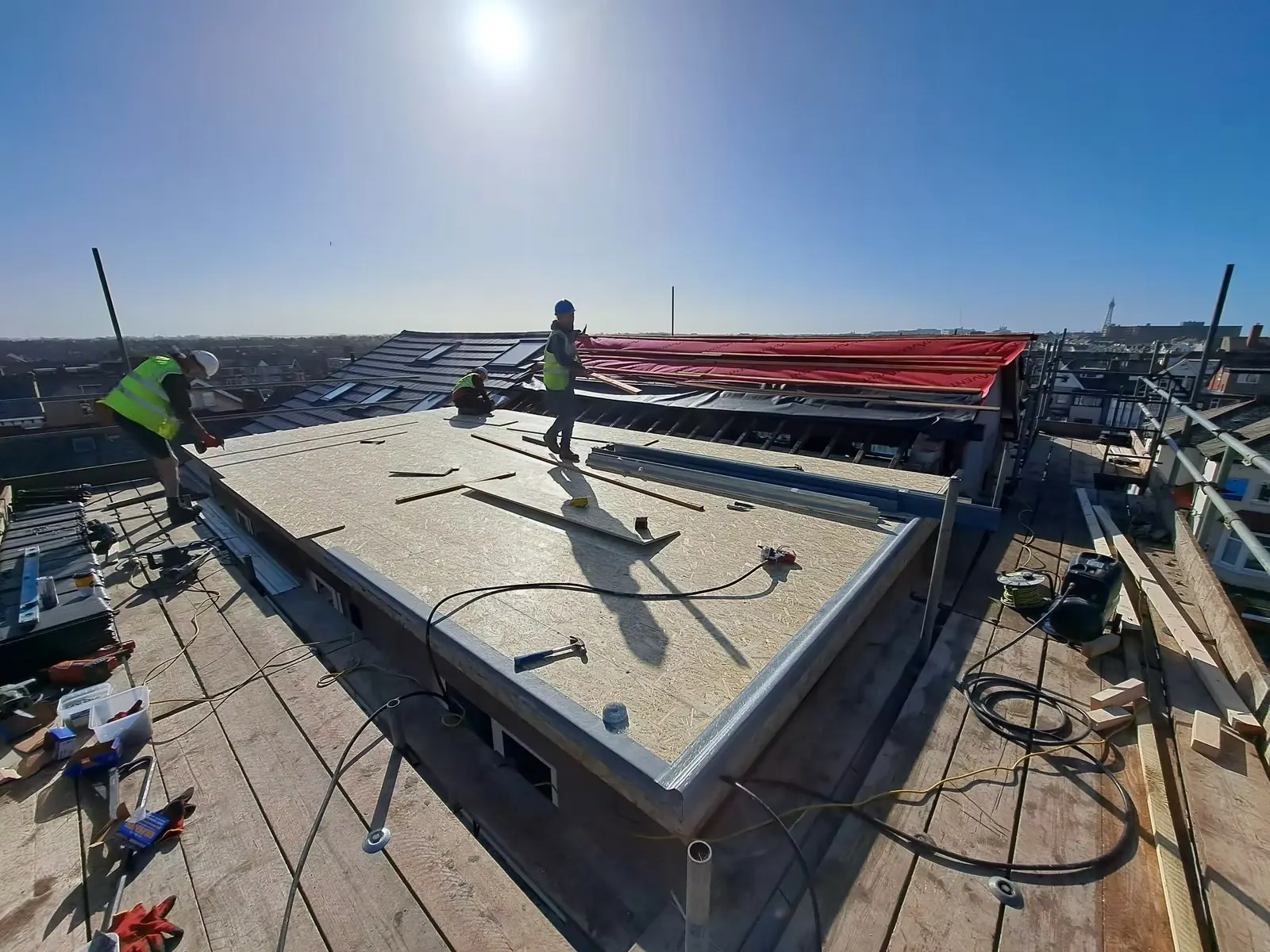 The Total Building North West team working in hard hats and hi-vis on a roof in Blackpool
